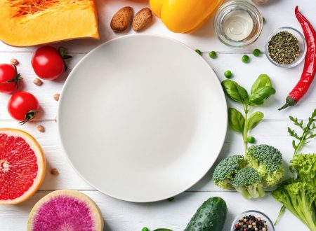 Fresh ingredients for vegetable salad and plate on wooden table. Diet food