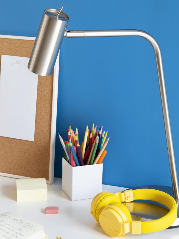 high-angle-children-s-desk-with-headphones-pencils